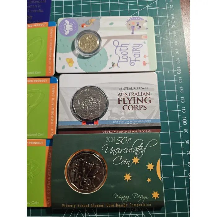 Bundle of wallet sized carded coins, 50 cent, $2- $5- commemorative 