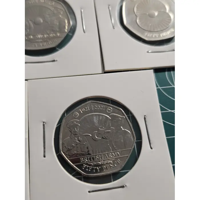 Mixture of British 50 pence, war, remembrance, poppy