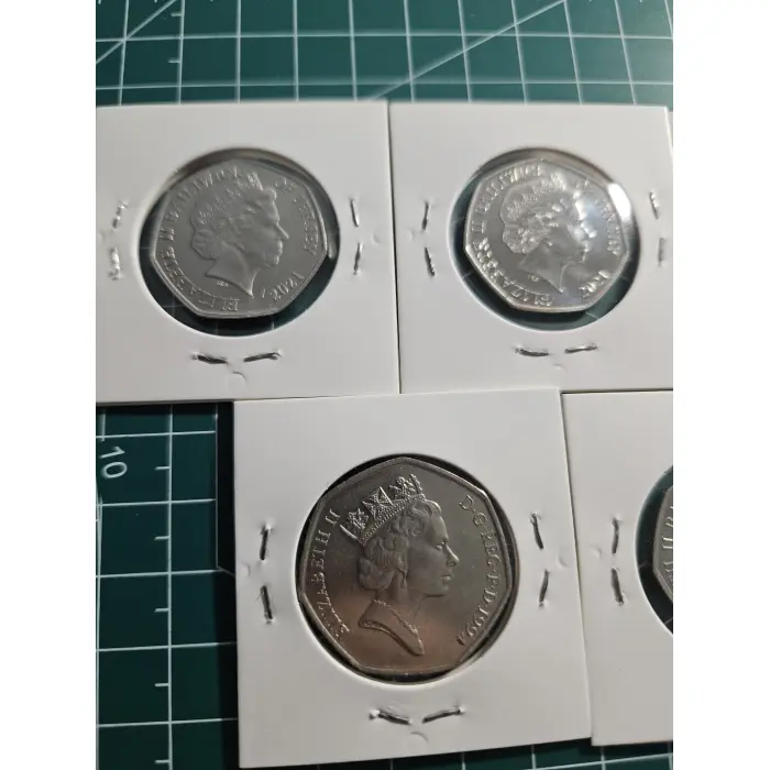 Mixture of British 50 pence, war, remembrance, poppy