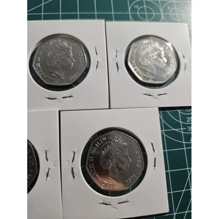 Mixture of British 50 pence, war, remembrance, poppy