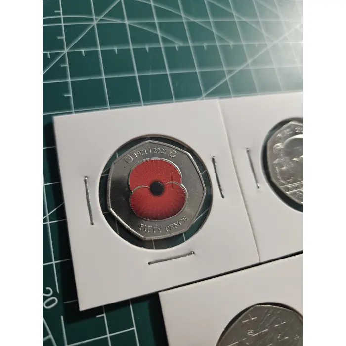 Mixture of British 50 pence, war, remembrance, poppy